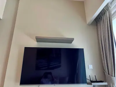 a large flat screen tv on a wall at Athesa Apartments Downtown Dubai Business Bay in Dubai