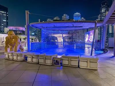 a large swimming pool in a city at night at Breathtaking view studio – Address Dubai Marina in Dubai