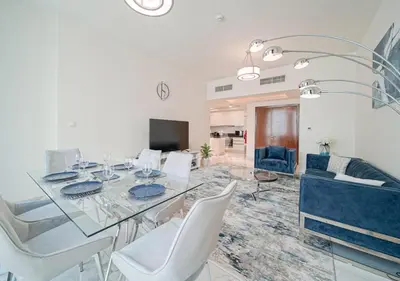a dining room with a glass table and white chairs at The stylish Meera tower 3606 apartment in Al Habtoor city in Dubai