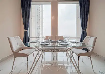 a glass table and chairs in a room with a window at The stylish Meera tower 3606 apartment in Al Habtoor city in Dubai