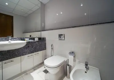a bathroom with a white toilet and a sink at The stylish Meera tower 3606 apartment in Al Habtoor city in Dubai