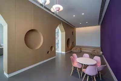a dining room with a table and pink chairs at TH-Homes Downtown 2 Bedroom with Burj Khalifa view in Dubai