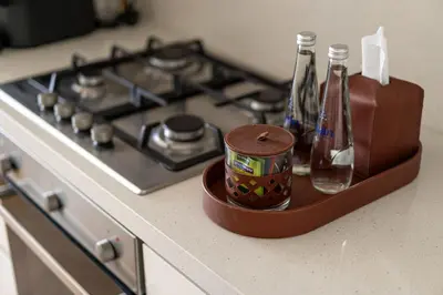 a container sitting on a counter next to a stove at TH-Homes Downtown 2 Bedroom with Burj Khalifa view in Dubai