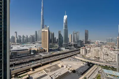 a view of a city with buildings and trains at TH-Homes Downtown 2 Bedroom with Burj Khalifa view in Dubai