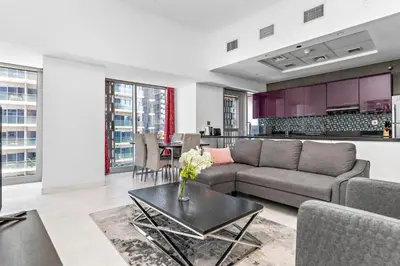 a living room with a couch and a table at StoneTree - Cayan Tower 2 BR - Best Location in Dubai
