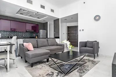 a living room with a couch and a table at StoneTree - Cayan Tower 2 BR - Best Location in Dubai