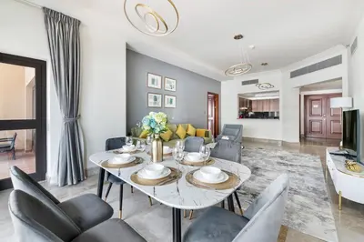 a living room with a dining table and chairs at StoneTree - Fairmont North 2 BR - Beach Access in Dubai