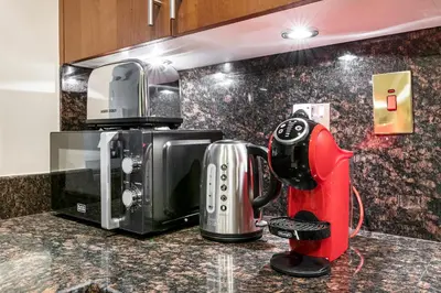 a kitchen with a coffee maker on a counter at StoneTree - Fairmont North 2 BR - Beach Access in Dubai