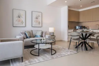a living room with a couch and a table at Creek View Apartment in Creek Harbour in Dubai