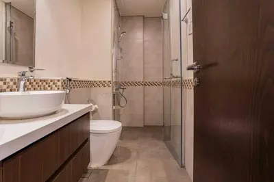 a bathroom with a toilet and a sink and a shower at TURQUOISE - Downtown Dubai 1 BEDROOM APARTMENT Business Bay - CANAL VIEW in Dubai
