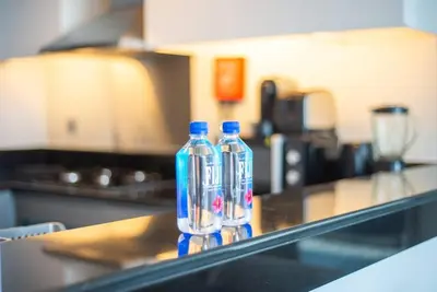 two bottles of water sitting on a counter in a kitchen at Upscale 1 bed apartment in Business Bay-Suiteable in Dubai