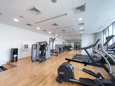 a gym with treadmills and elliptical machines at Lush Tropical Getaway in Dubai Marina in Dubai