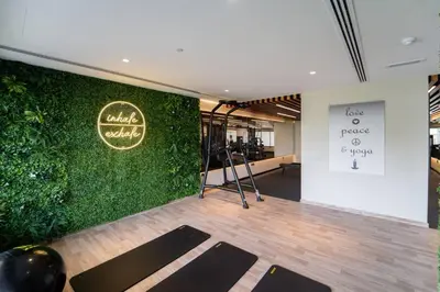 a room with a green wall with yoga mats at Romantic hideaway w breathtaking Burj Khalifa view in Dubai