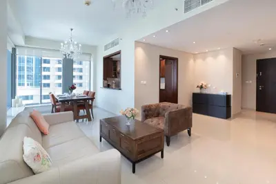 a living room with a couch and a table at Downtown Dubai, Luxury 2 Bed 2 Bath Apartment - Pool, Gym, AirCon, Parking - Views of The Dubai Fountain & Burj Khalifa in Dubai