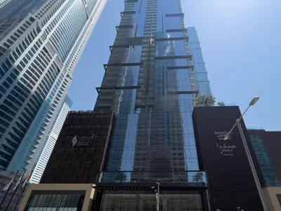 a tall building in a city with tall buildings at GuestReady - Luxury 1BR | Skyline & Canal View in Dubai