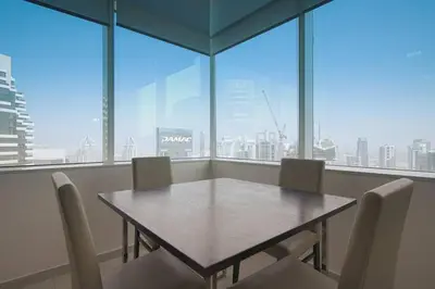 a table and chairs in a room with a large window at StoneTree - Botanica Tower 1 BR - Close to Beach in Dubai