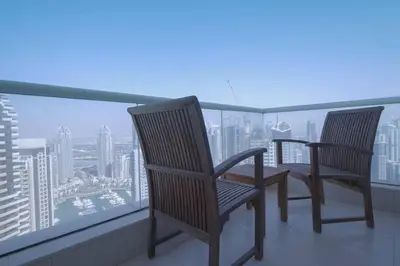 two chairs on a balcony with a view of a city at StoneTree - Botanica Tower 1 BR - Close to Beach in Dubai