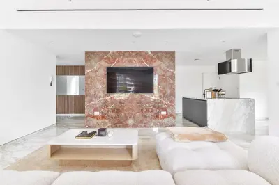 a living room with a white couch and a fireplace at Stunning 1BR in Bahar near JBR Beach in Dubai