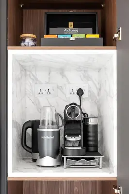a shelf with a tea kettle and a blender at Stunning 1BR in Bahar near JBR Beach in Dubai
