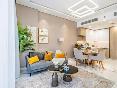 a living room with a couch and a table at Charming Condo With Balcony Near Dubai Hills Park in Dubai