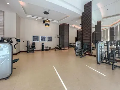 a gym with treadmills and cardio equipment in a room at New Listing - Serviced Apartment & TOP Amenities in Dubai