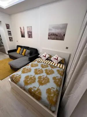 a bedroom with a bed and a couch at Modern Studio Center of Dubai in Dubai