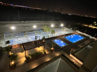 an overhead view of a swimming pool at night at Modern Studio Center of Dubai in Dubai